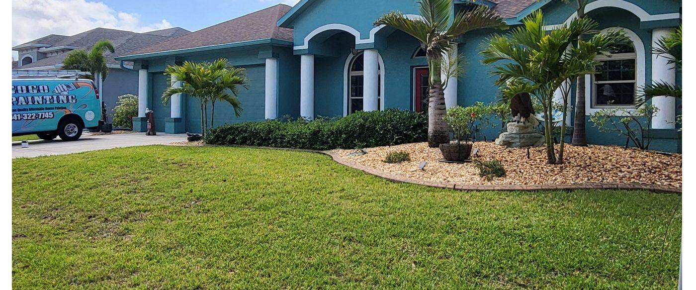 Exterior repaint finished by GOGO Painting in Southwest Florida, company van on the driveway